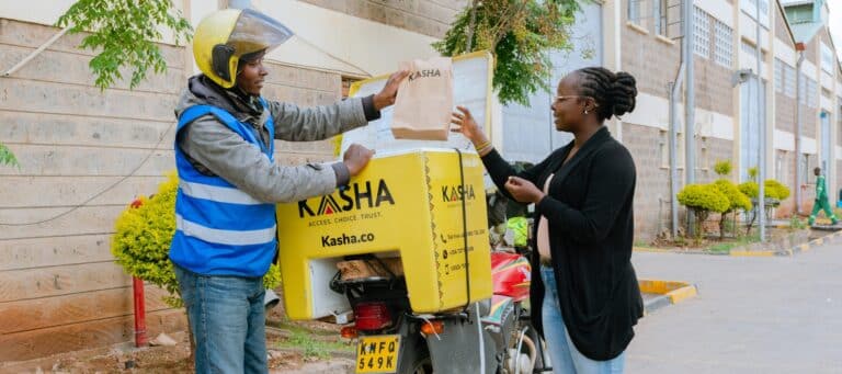 KASHA delivery driver delivers parcel to woman on the side of the road.