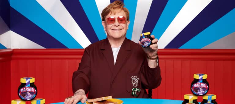 Elton John holds up limited edition jar of Marmite.